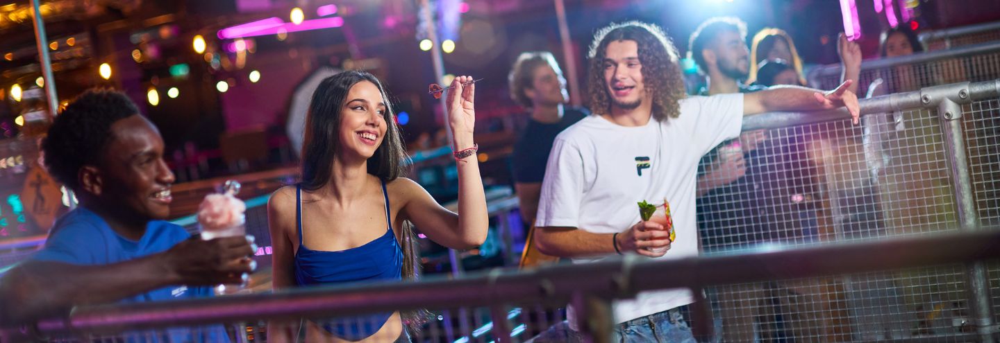 a group of friends playing darts