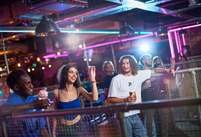 a group of friends playing darts